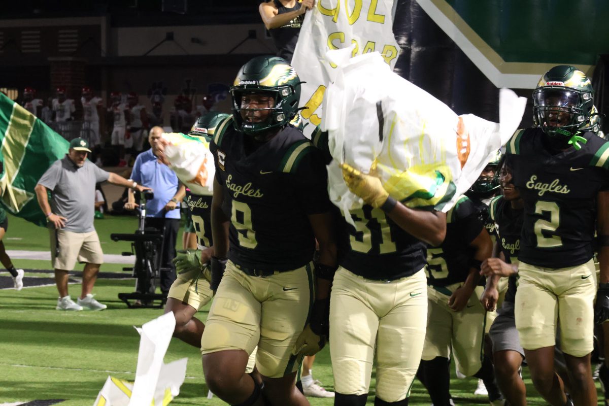 Cypress Falls defensive end Kaden McCarty (#9) takes the field with his teammates.